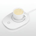 White mug warmer with a cup of coffee on a white background.