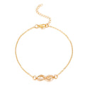 Gold bracelet with an infinity symbol on a white background