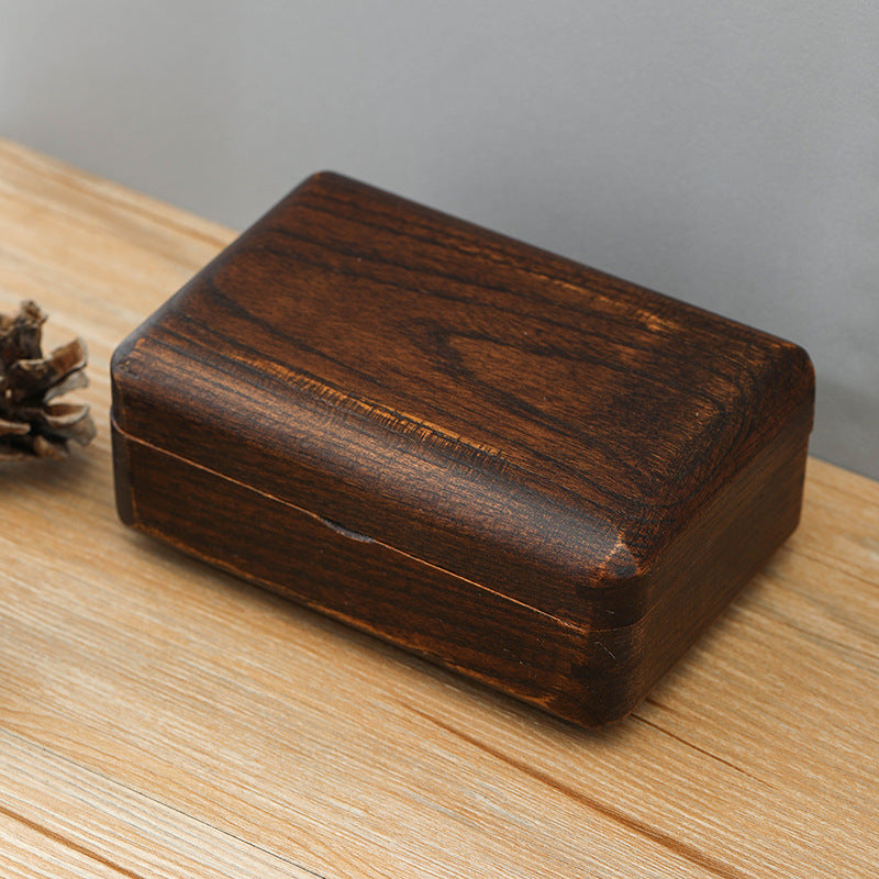 Wooden box on a wooden surface with a gray background