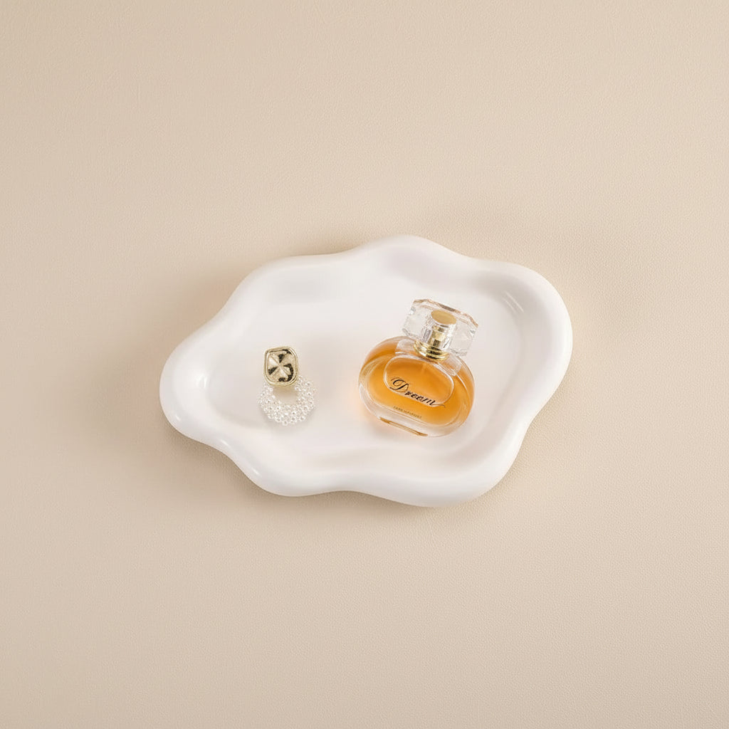 Ceramic dish with a perfume bottle on a beige background, featuring text about material properties.