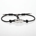 Two black cord bracelets with silver ends on a white background, labeled 'with envelope'.