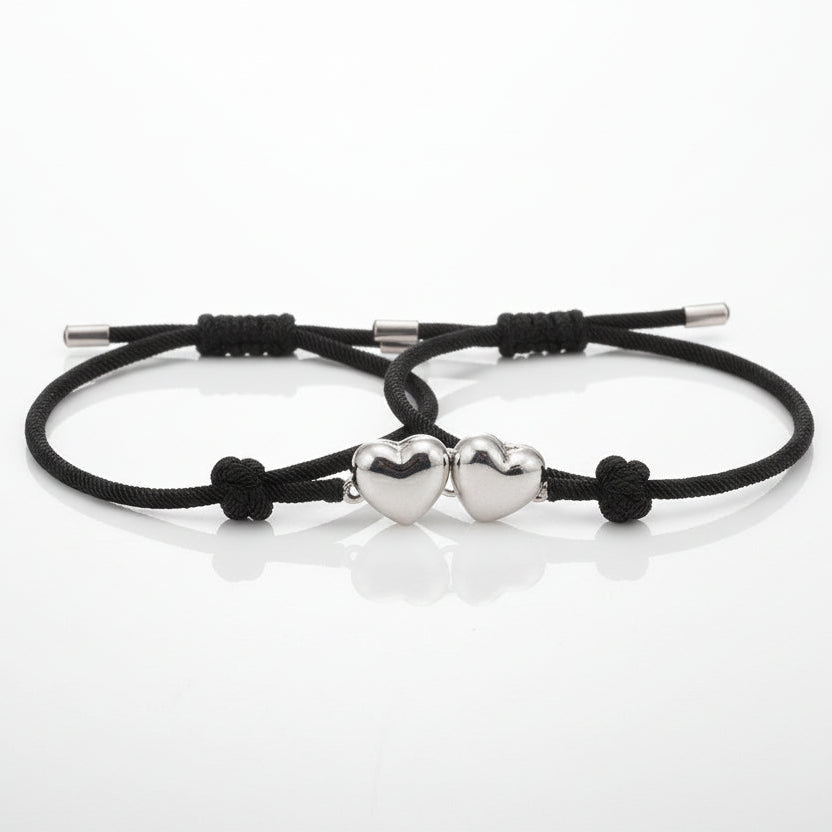 Two black cord bracelets with silver ends on a white background, labeled 'with envelope'.