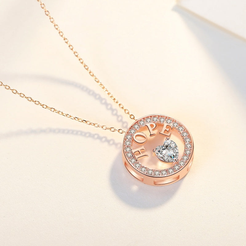 Rose gold necklace with 'HOPE' pendant on a light background