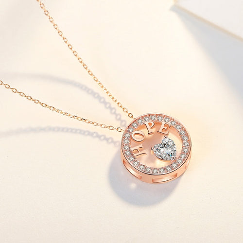 Rose gold necklace with 'HOPE' pendant on a light background