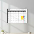 Dry erase calendar with markers on a white background