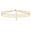 Gold chain necklace with a small pendant on a white background