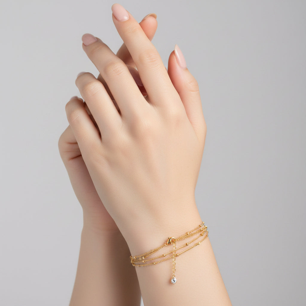 Gold chain necklace with a small pendant on a white background