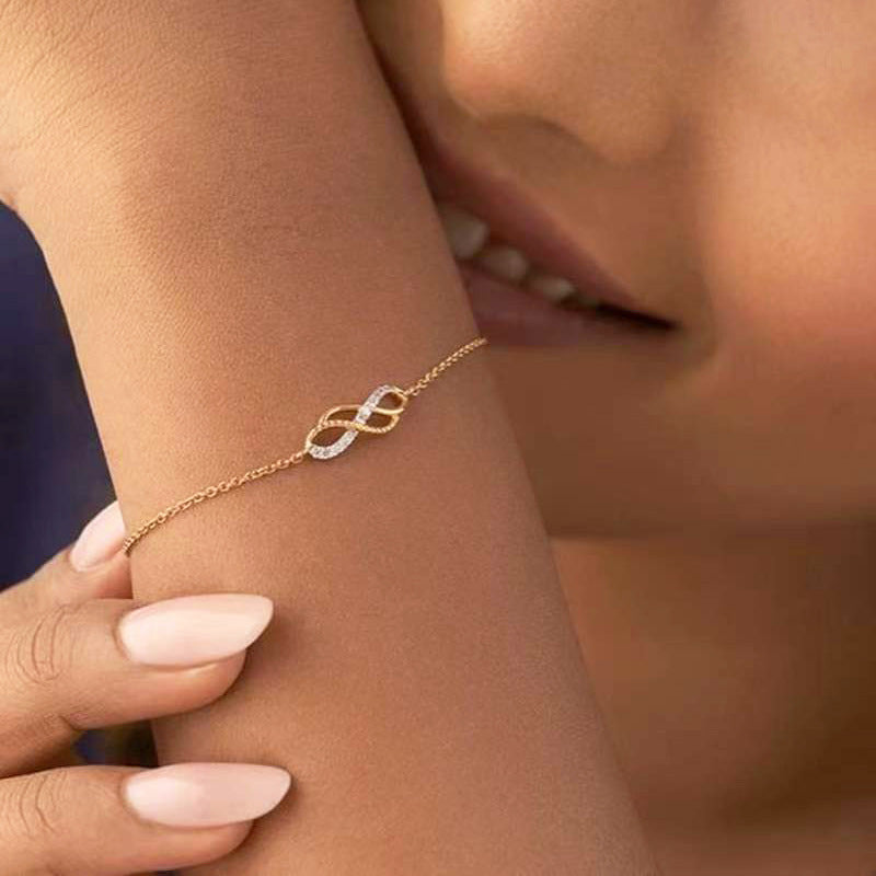 Gold bracelet with a diamond on a wrist