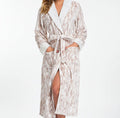 Woman wearing a patterned robe on a white background