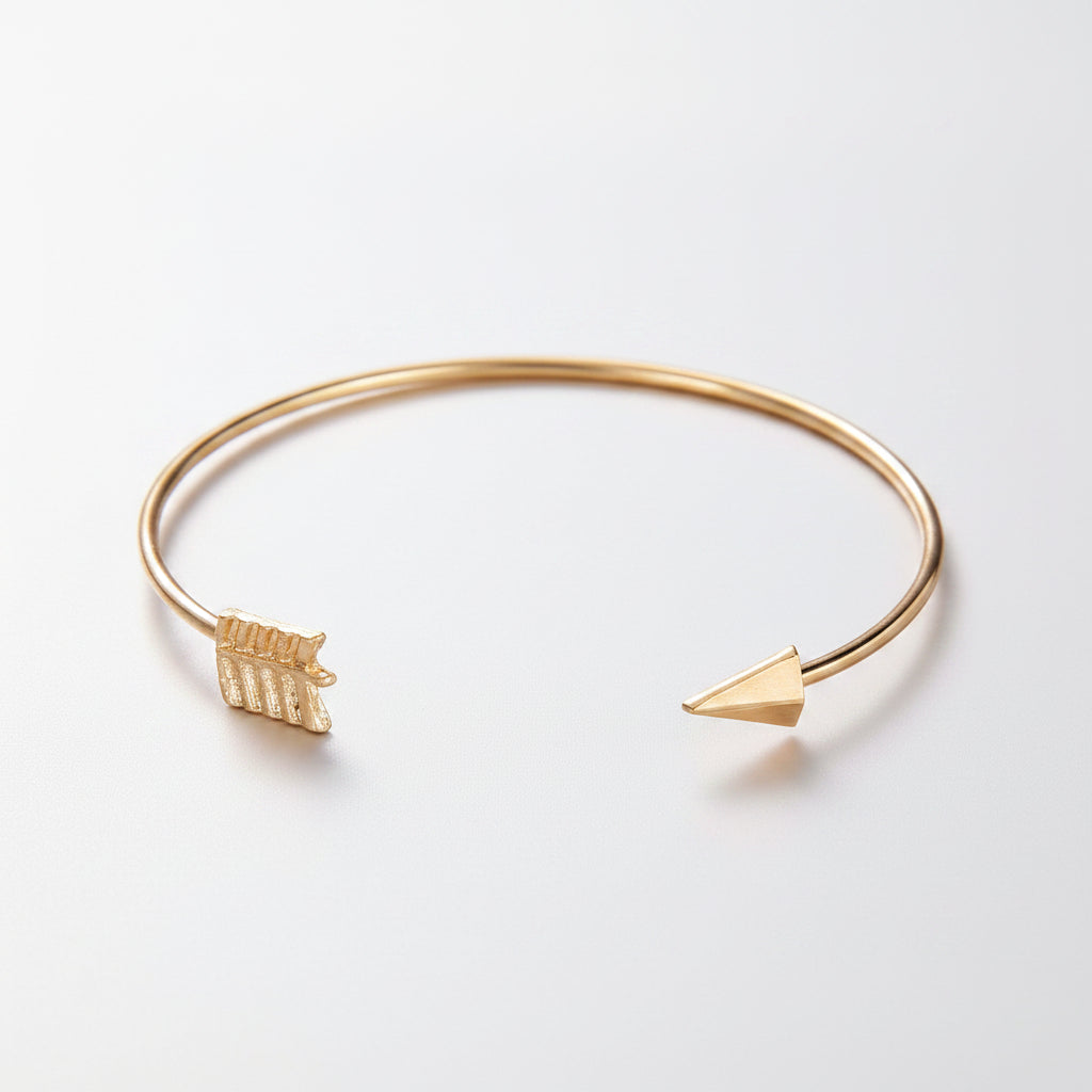 Gold bracelet with geometric charms on a white background
