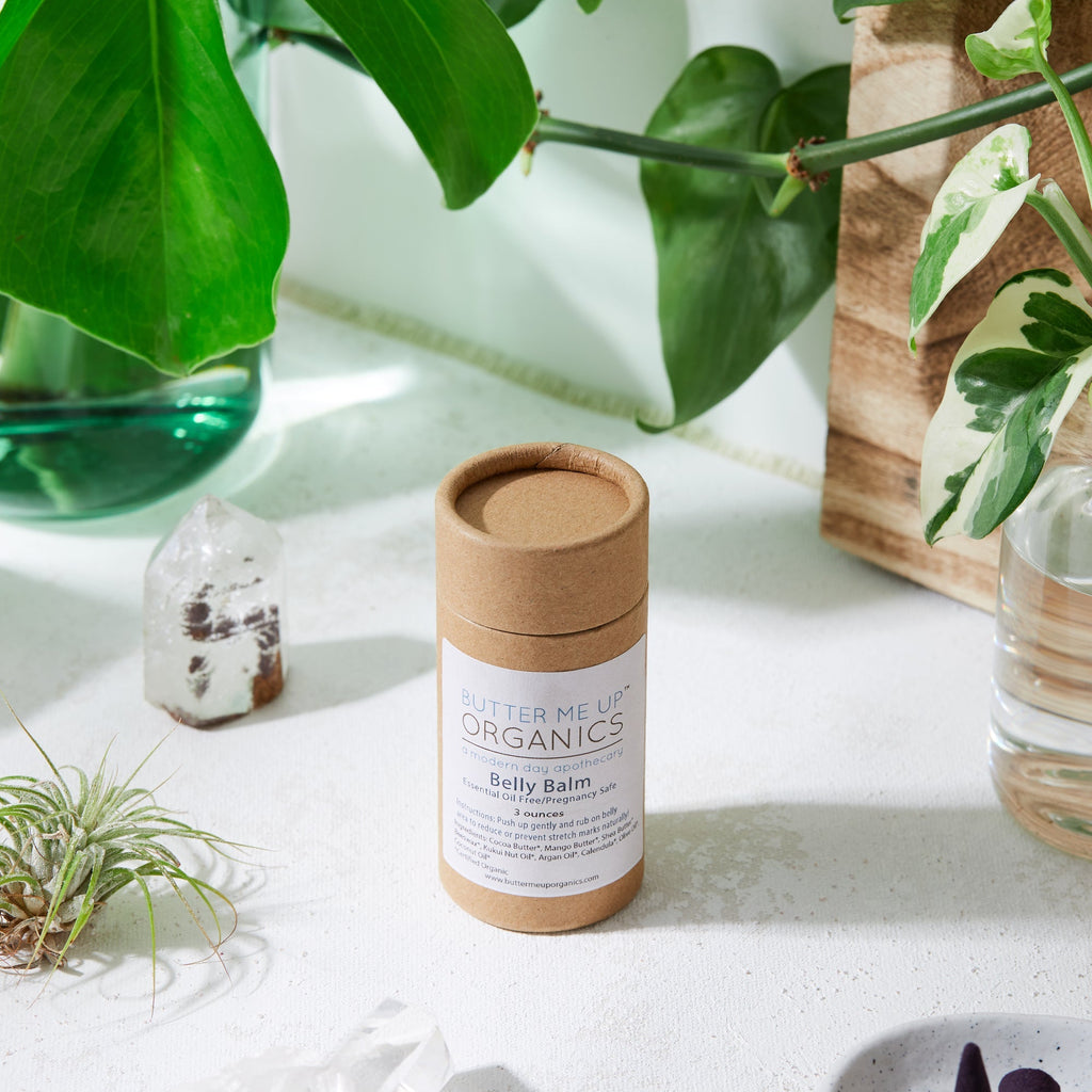 Bamboo tube with label on a white surface with plants in the background
