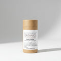 Butter Me Up Organics belly balm on a white plate with green leaves