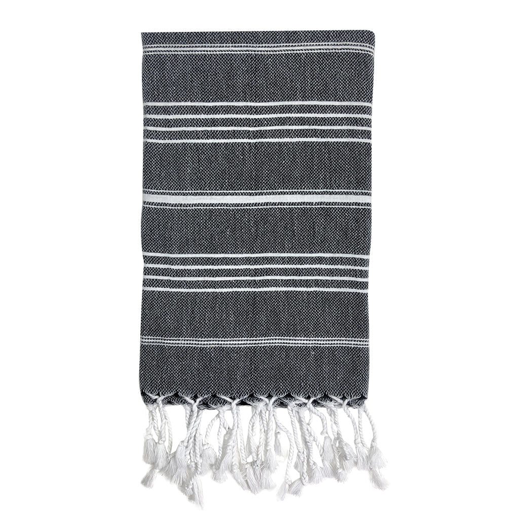 Black towel with white stripes and fringes on a white background
