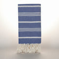Blue towel with white stripes and fringes on a white background