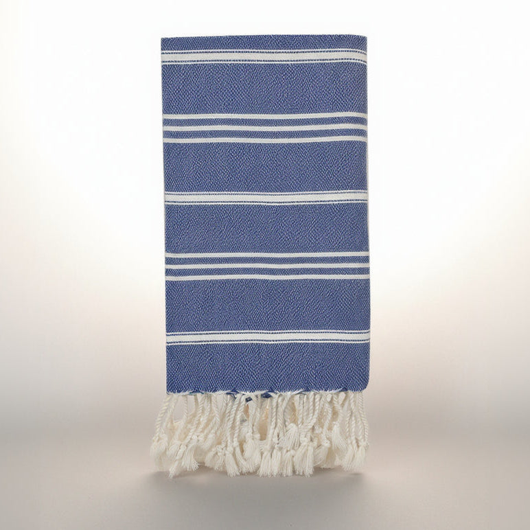 Blue towel with white stripes and fringes on a white background