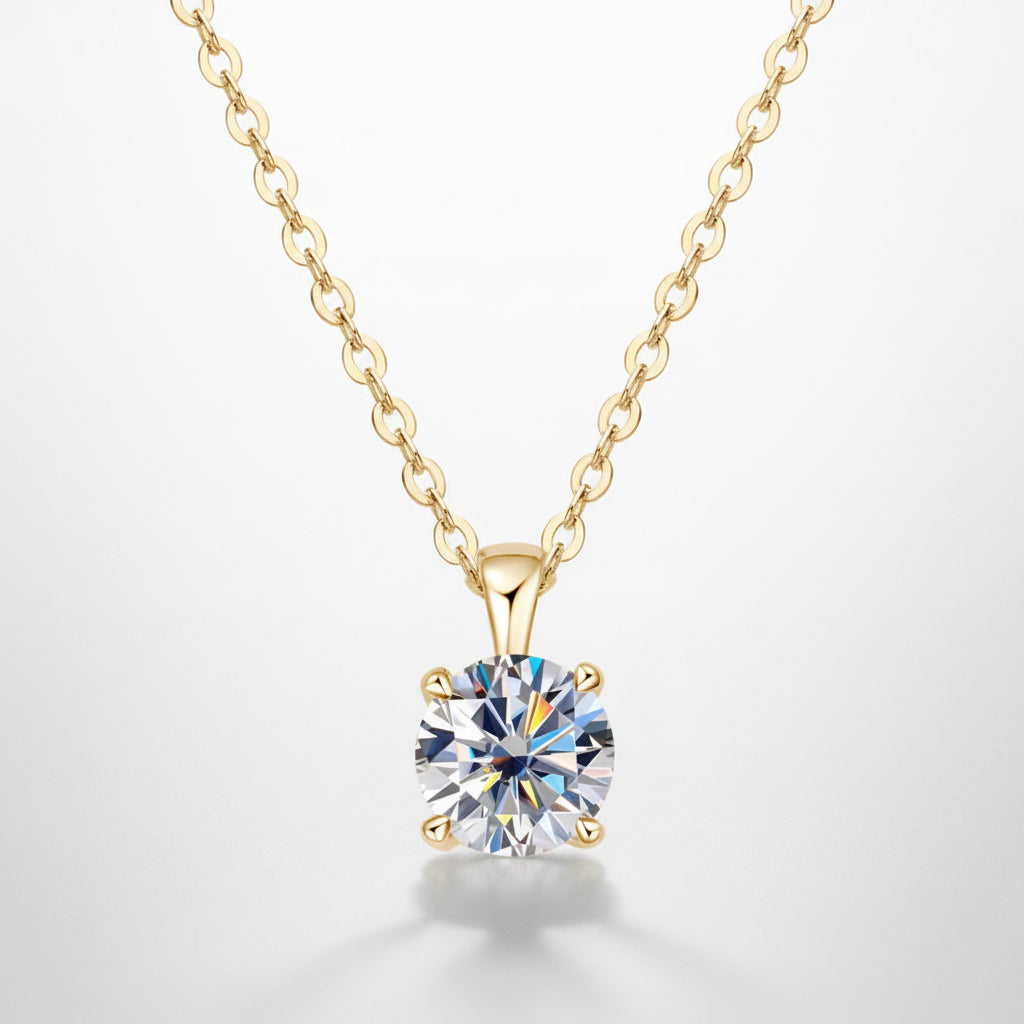 Gold necklace with a round diamond pendant on a white background