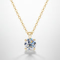 Gold necklace with a round diamond pendant on a white background