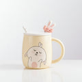 Mug with a rabbit design on a desk with office supplies
