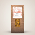 Brown paper bag with a window displaying dried herbs and a label on a beige background