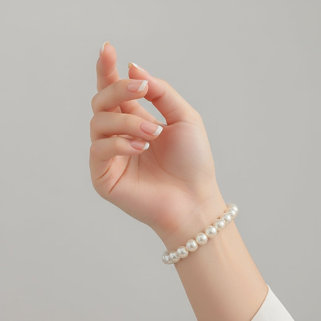 Pearl bracelet on a wrist with a close-up of the bracelet and measurement label.