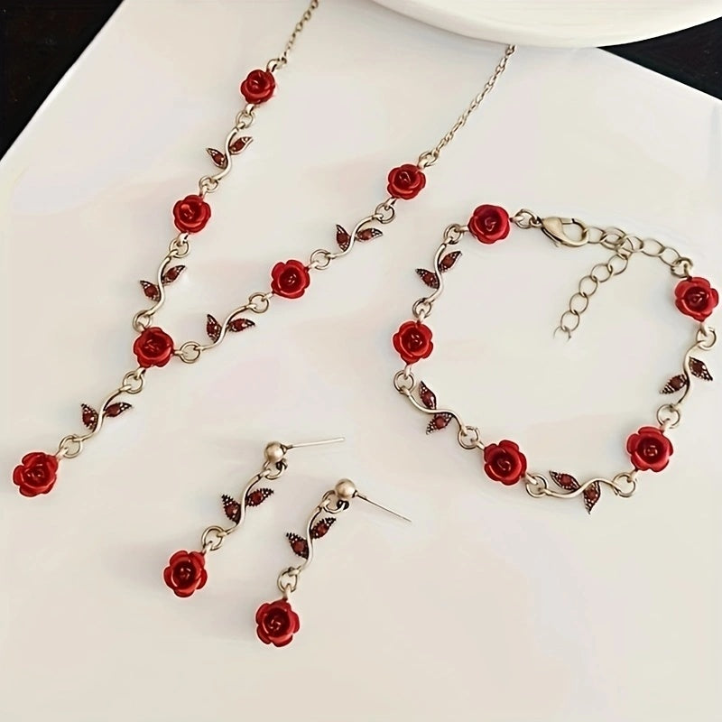 Jewelry set with red rose details on a white background