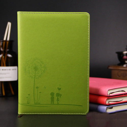 Green notebook with a dandelion design on a dark background