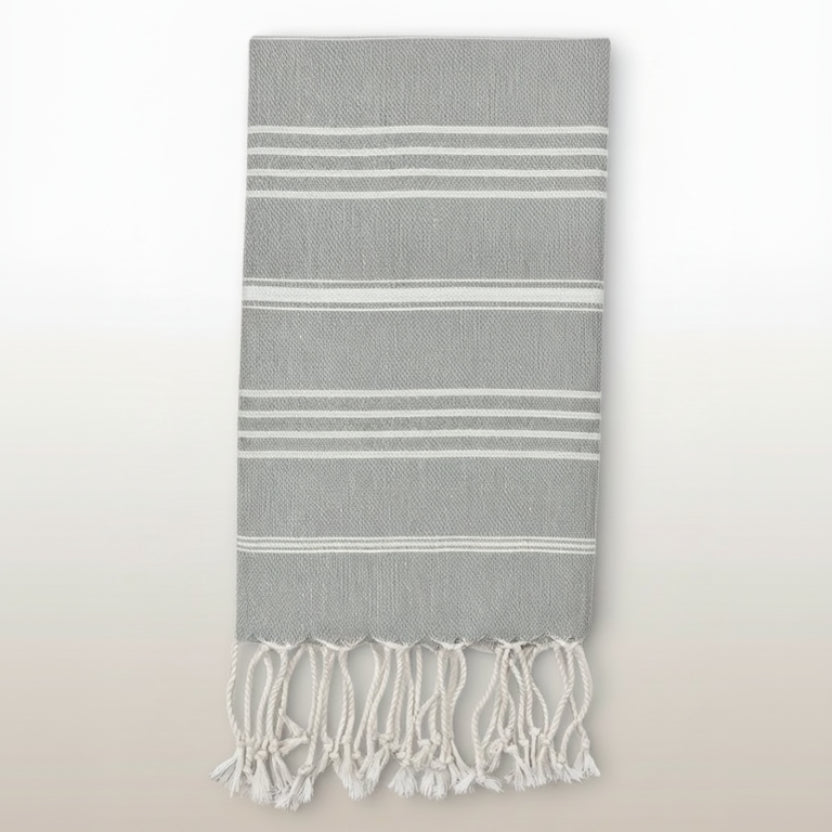 Gray towel with white stripes and fringes on a white background