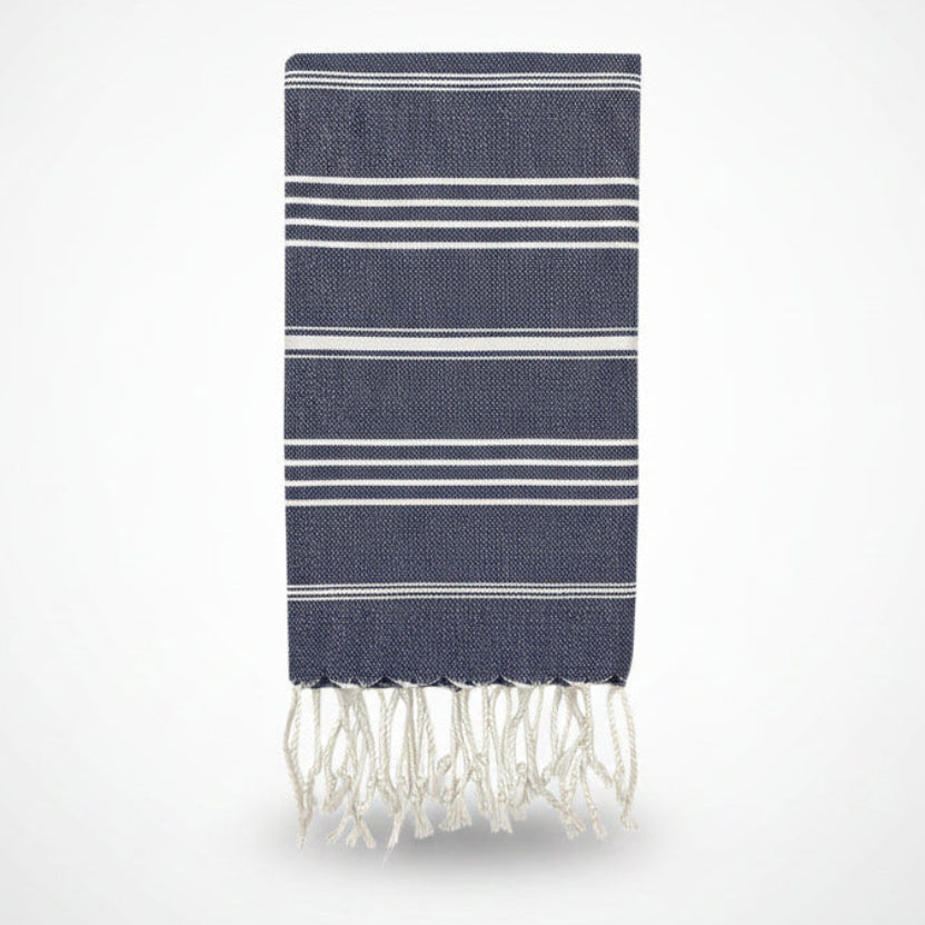 Navy blue towel with white stripes and fringes on a white background