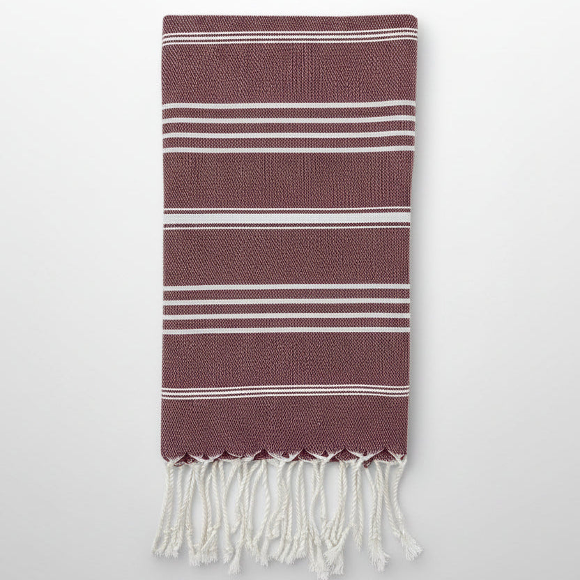Striped towel with fringes on a white background