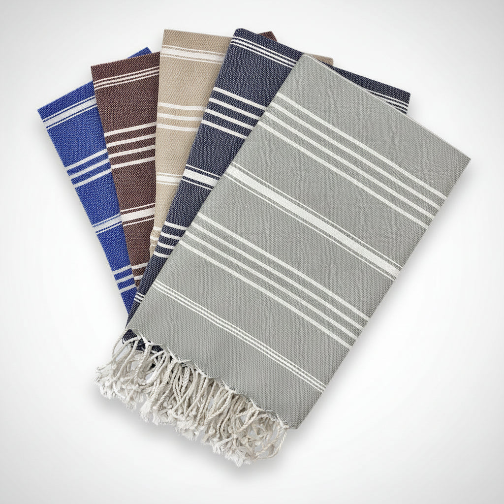 Set of six striped towels in various colors on a white background